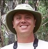 A male bird watcher smiling